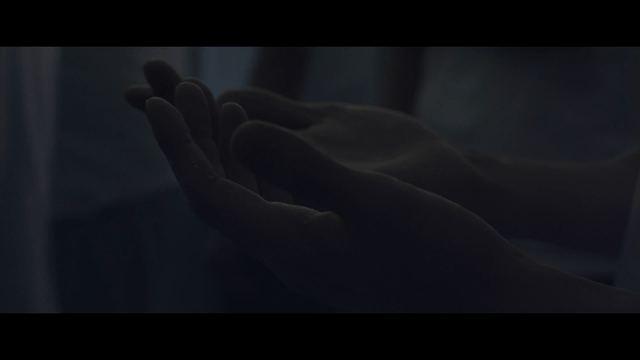 Hand with white powder in dark room
