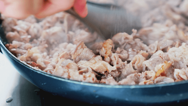 Meat being cooked in a pan