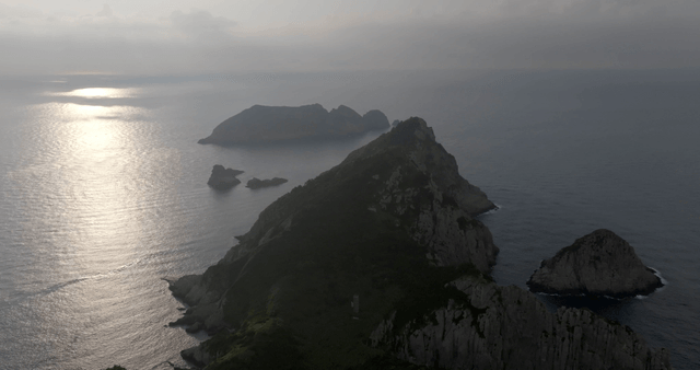 A serene island with surrounding sea