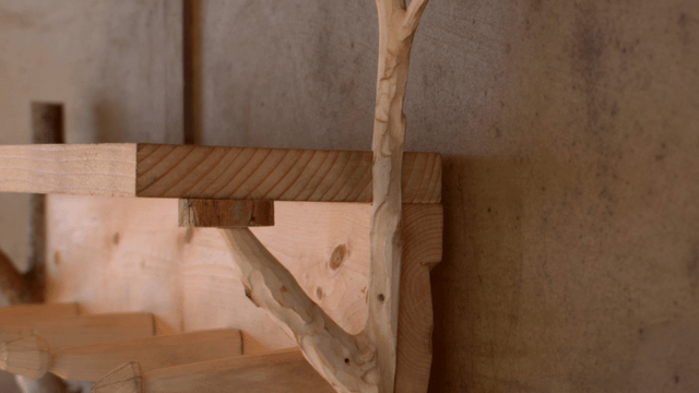Wooden shelf supported by natural branches