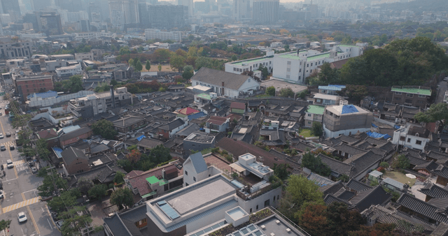Panoramic view of a Hanok village lined with traditional tiled roofs