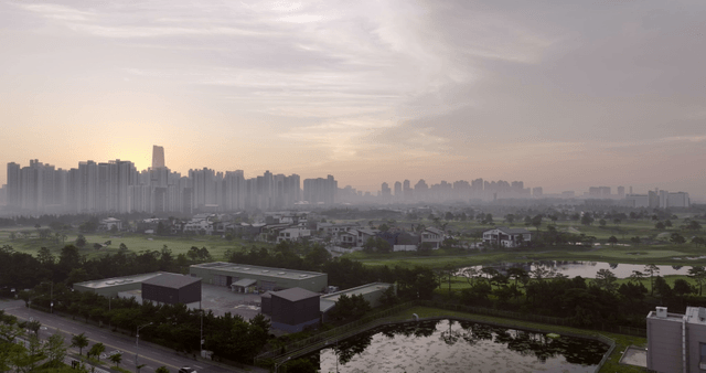 City skyline at dawn with misty atmosphere