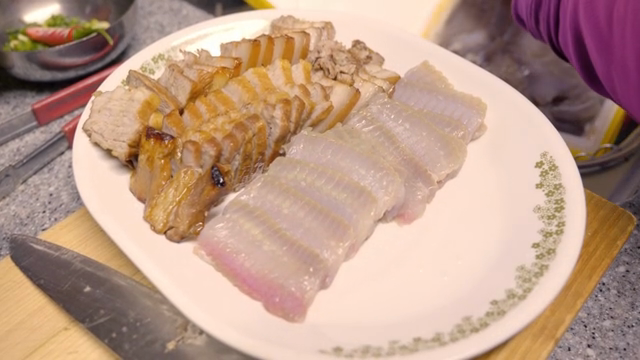 Sliced pork and raw skate on a plate