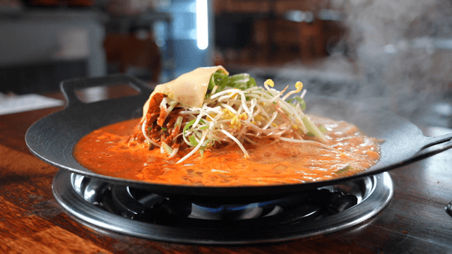 Budaejjigae boiling on tabletop burner