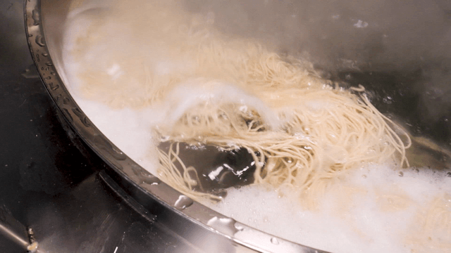 Buckwheat noodles boiling in a large pot