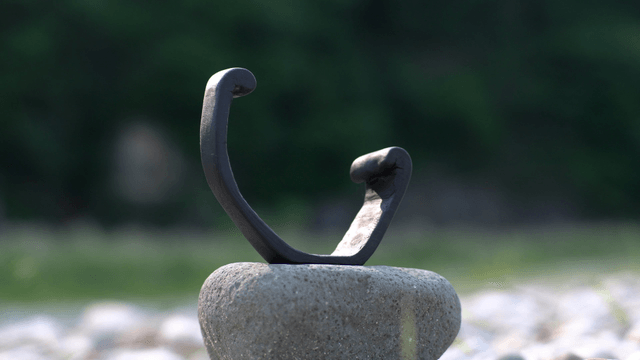 Wooden sculpture on a stone in nature