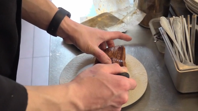 Chef preparing a pastry dish in the kitchen