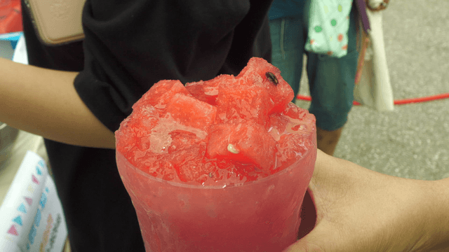 Hand holding street-style watermelon cup bingsu