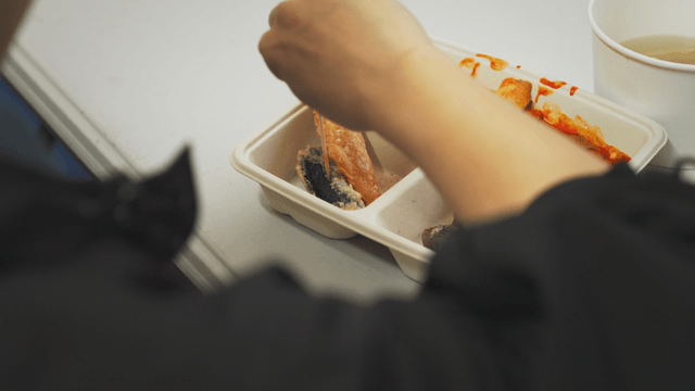 Person skewering fried gim-mari