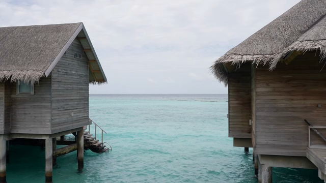 Overwater bungalows by the turquoise sea