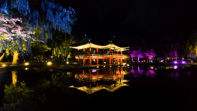 Night lights surrounding a traditional pavilion