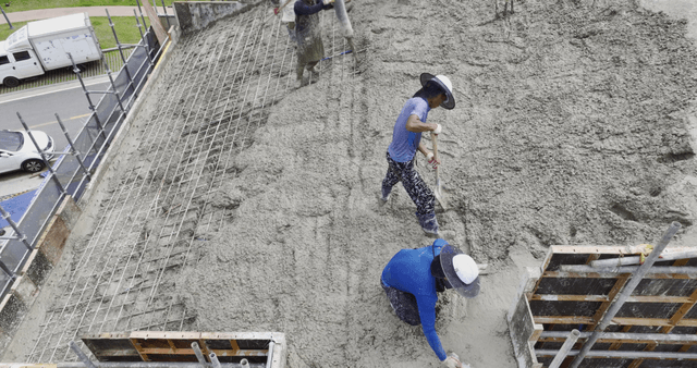 Workers pouring concrete on a building site