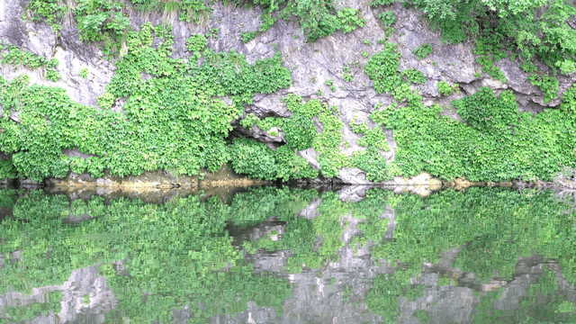 Gently flowing river beneath the blue cliff