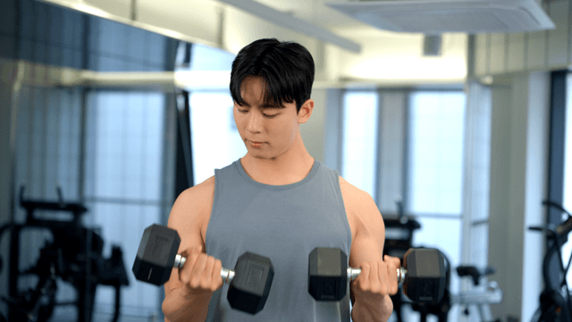Man lifting dumbbells in a gym