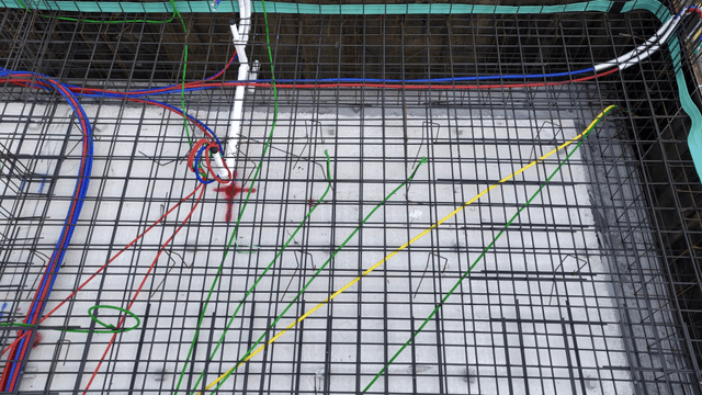Colorful wires and steel bars at a construction site