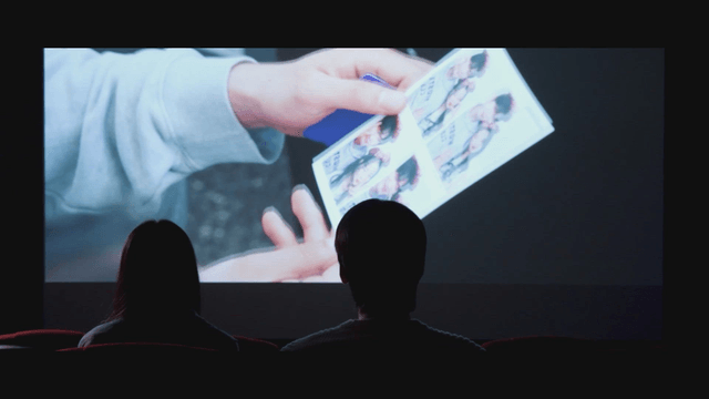 Back view of a couple watching a movie at a cinema