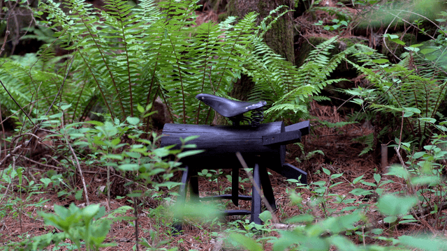 Wooden sculpture in a lush green forest