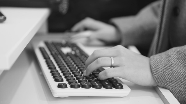 Hands on a keyboard in an office