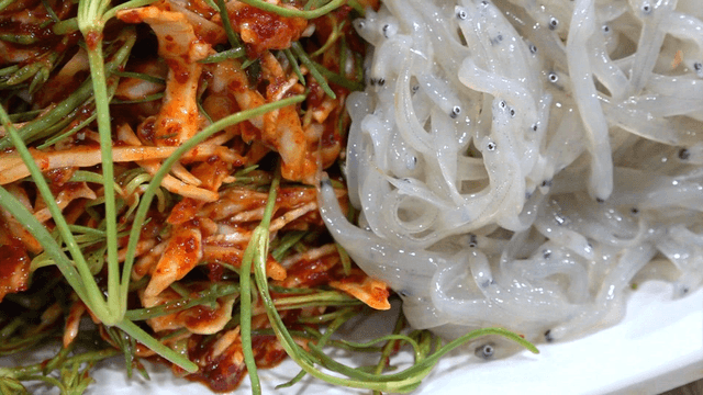Fresh ice fish salad with vegetables on white plate