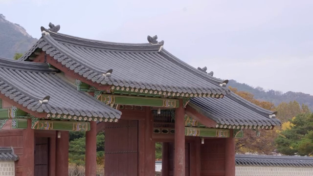 Traditional Korean architecture with mountains