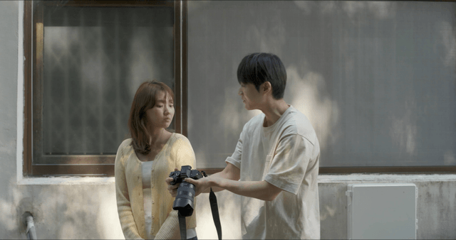 Couple conversing outdoors with a camera