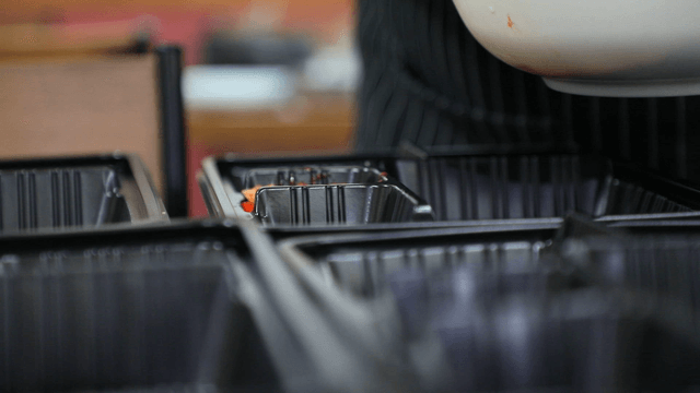 Preparing food with tongs in a kitchen