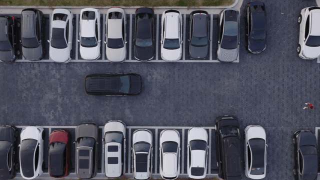 Aerial view of a parking lot with cars