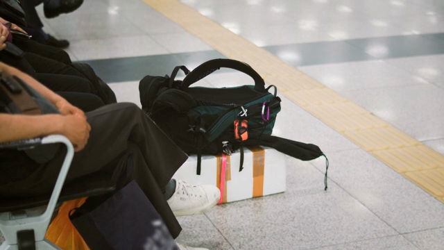 People waiting at a terminal with luggage