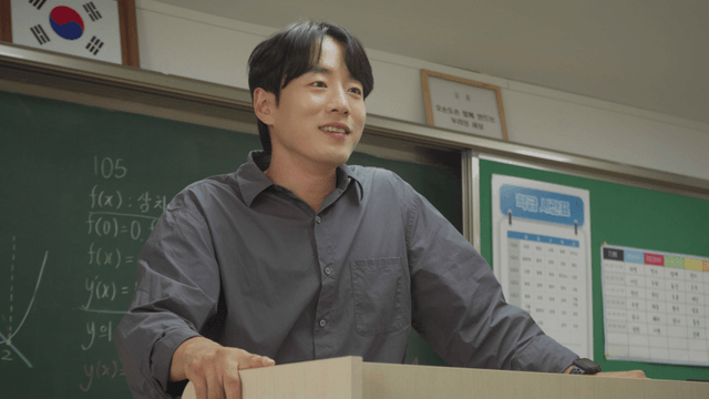 Teacher smiling while teaching in the classroom