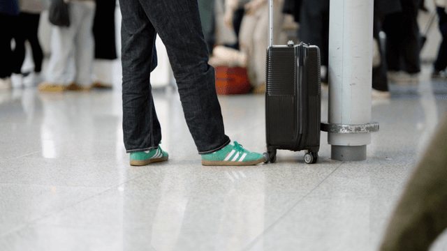 Traveler waiting with luggage at airport