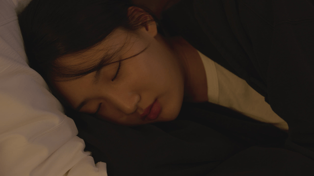 Woman resting her head on a pillow