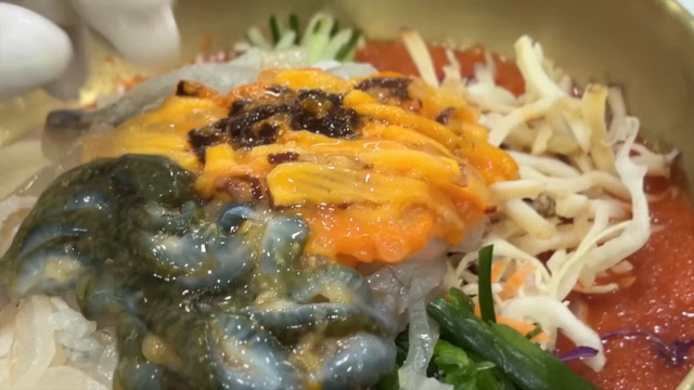 Preparing Cold Raw Fish Soup with fresh sea pineapple on top