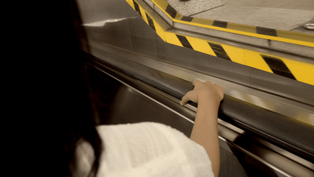 Person holding the handrail on an escalator