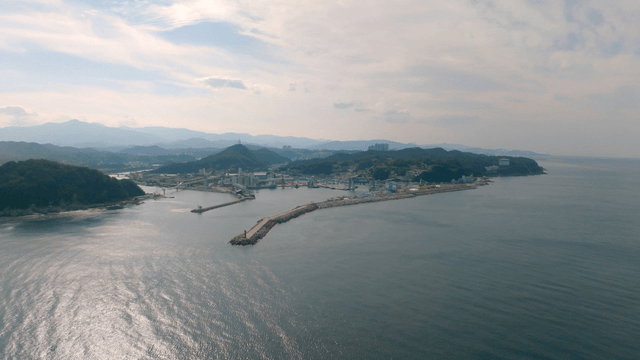Vast sea in front of a scenic harbor