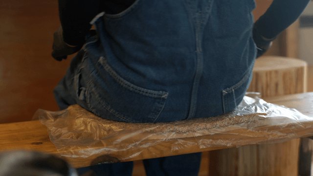 Woodcraft artisan shaping wood with sawdust flying