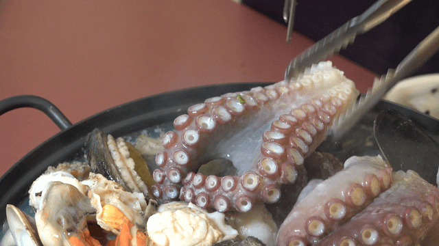 Chicken and seafood soup being prepared in a pot