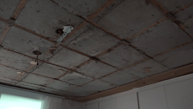 Exposed ceiling with visible wiring at construction site