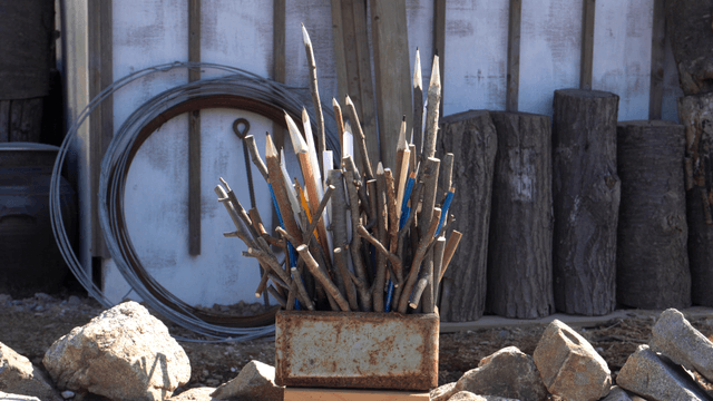 Wooden branch pencil sculpture with warehouse background