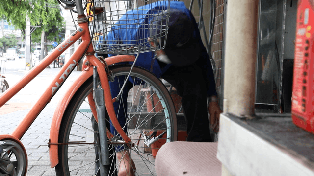 Person fixing a bicycle on the street