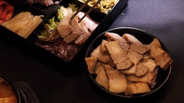 Meat being transferred onto a plate