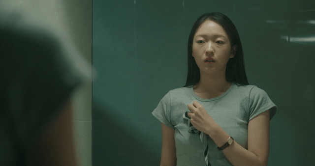 Woman wiping armpit sweat in a bathroom