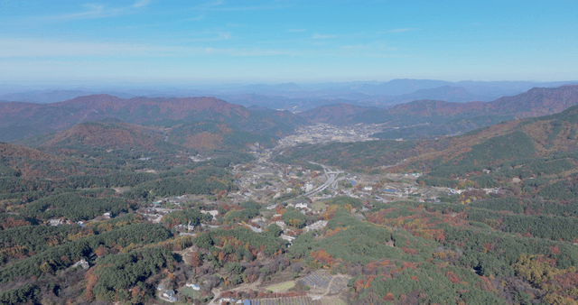 Expansive mountain landscape with autumn foliage