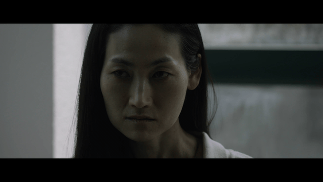 Woman with a serious expression indoors