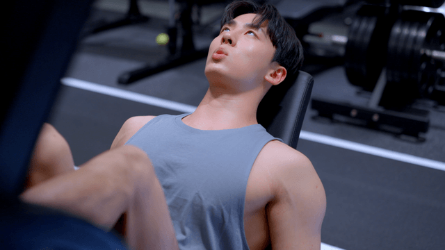 Man doing leg press exercise at gym with focus