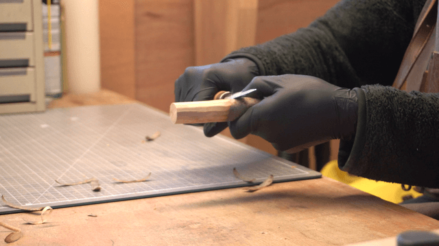 Artisan carving wood precisely with a knife