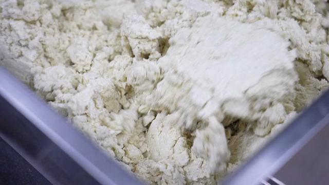 Dough being mixed in a large bowl