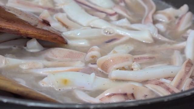 Squid being boiled in a pot with water