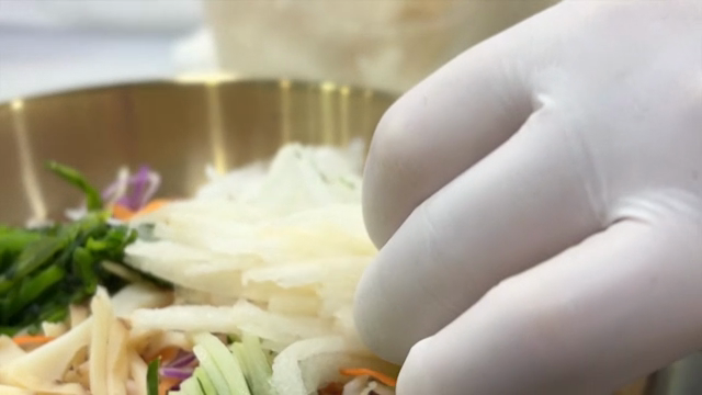 Finishing Cold Raw Fish Soup with fresh vegetables