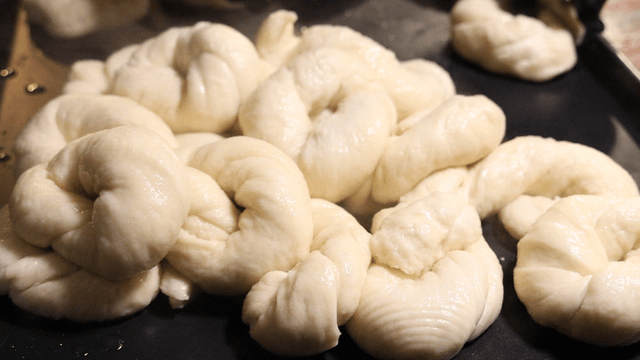 Boiled bagels on a baking tray
