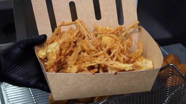 Freshly fried enoki mushrooms in a paper box